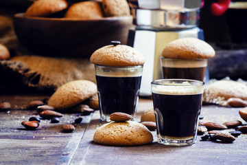 Black coffee and almond biscuits, vintage wooden background, sel