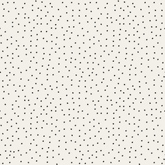 Seamless repeat pattern with hand drawn dots in black on white background.