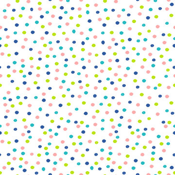 Abstract seamless pattern with dots in pastel pink, blue and green.

