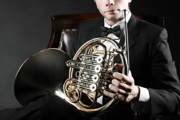 French horn player with musical instrument