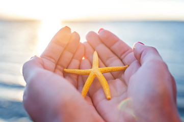 young woman hands holding sand on the beach. natural summer backgound