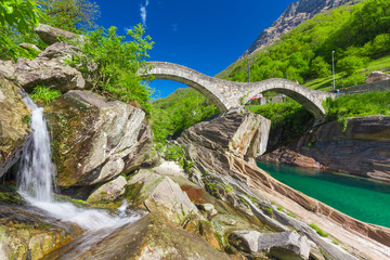 Fototapeta na wymiar Double arch stone bridge at Ponte dei Salti with waterfall, Lavertezzo, Verzascatal, Canton Tessin.