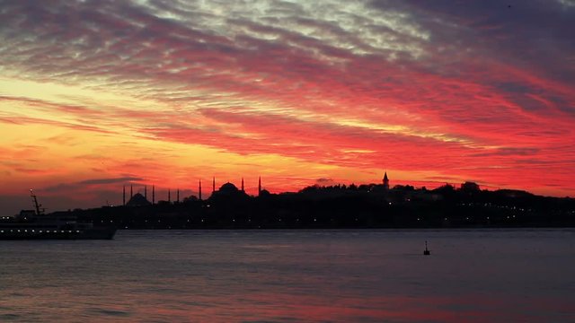 Sunset at Istanbul. Setting sun fired up the sky and Bosphorus waters
