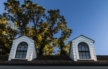 Dormers On A Black Shingle Roof. Double dormers on a black shingle roof with white siding and black trim.
