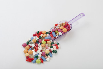 Fototapeta na wymiar Many colorful pills isolated on white background