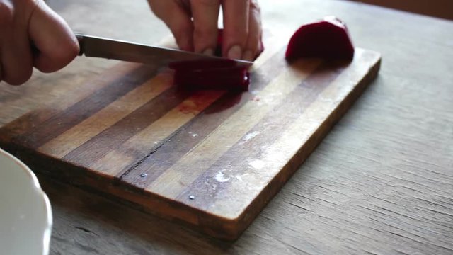 Cutting beet on a board chef cooking