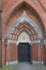 Fragment of the wall and the entrance and the door to the cathed