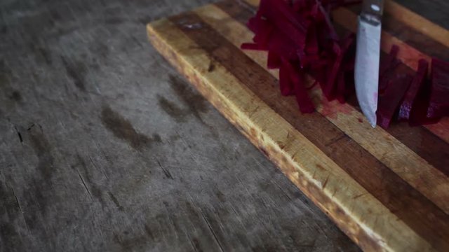 Cutting beet on a board chef cooking