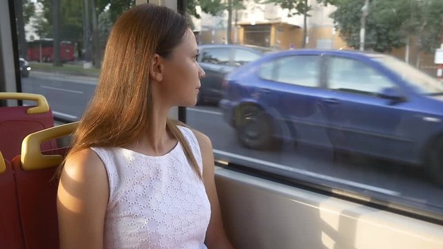 Woman looks out the window of tram