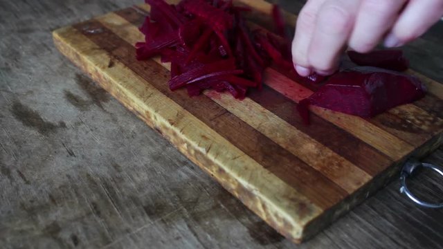 Cutting beet on a board chef cooking