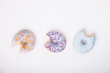 Donuts in colored glazes on a white background.Pastries,dessert.Copy space.selective focus.