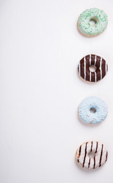 Donuts in colored glazes on a white background.Pastries,dessert.Copy space.selective focus.