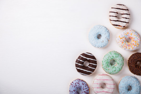 Donuts in colored glazes on a white background.Pastries,dessert.Copy space.selective focus.