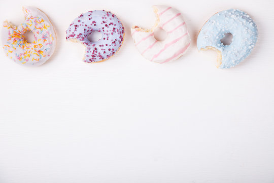 Donuts in colored glazes on a white background.Pastries,dessert.Copy space.selective focus.