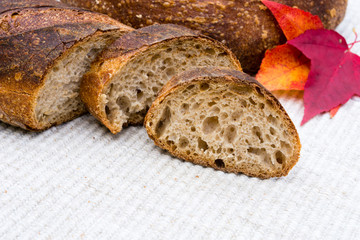 Slices of homemade artisan bread with red fall leaves