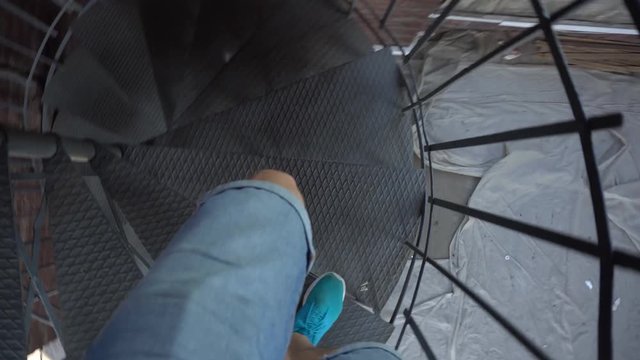 Man Walking Down the Corkscrew Staircase