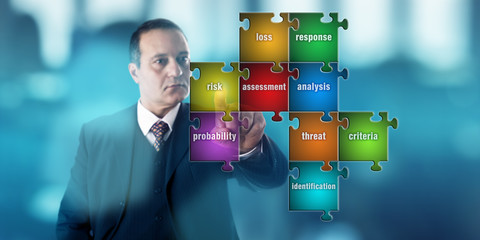 Businessman Focussing On A Risk Assessment Puzzle