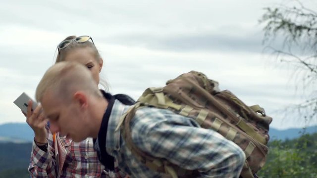 Girl asking a bou about the way while standing on the hill, steadycam shot
