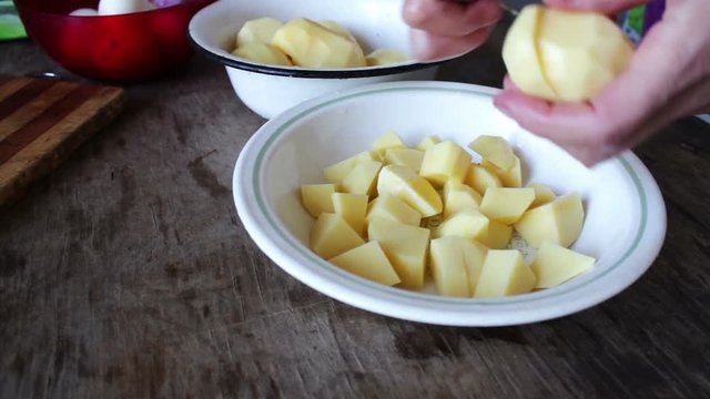 Chef cutting Potato with knife