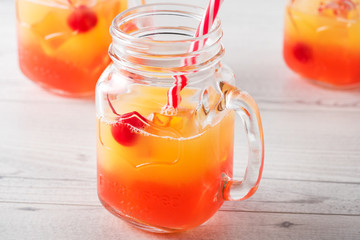 Tequila sunrise cocktails in glass jar
