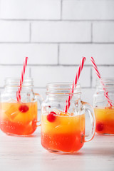 Tequila sunrise cocktails in glass jar