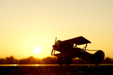 Sunset silhouette of old bi plane