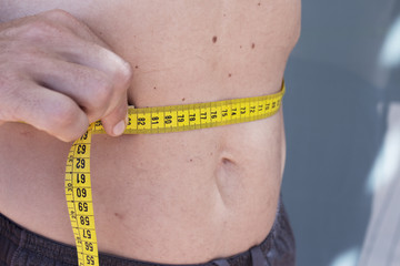 Man measuring body contouring