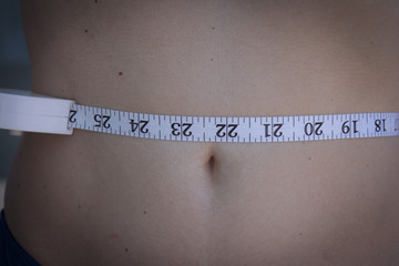 Woman measuring body contouring