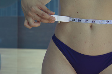 Woman measuring body contouring