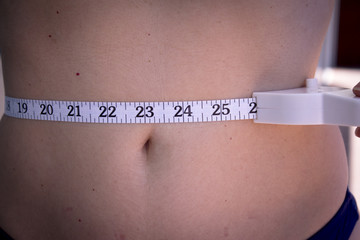 Woman measuring body contouring