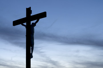 Silhouette of Jesus on a Cross with Blue Sky
