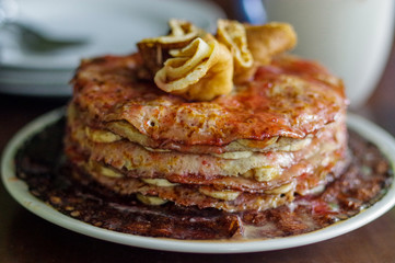Closeup of a stack of banana nut pancakes on a wooden table