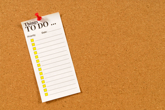To do list pinned to cork bulletin board with pushpin photo