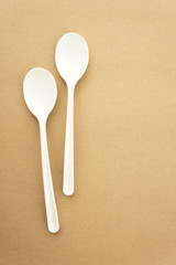 Twin spoons on brown background ,White spoon, The device is one