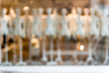 De focused/Blur image of boutique window with dressed mannequins. Boutique display window with...