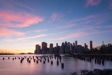 Fototapeta na wymiar Golden hour in Brooklyn New York looking at a Brooklyn dock on the left and lower Manhattan on the right