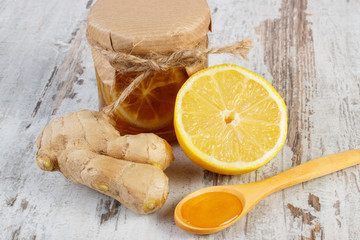Fresh lemon, honey and ginger on wooden table, healthy nutrition