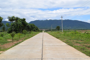 Fototapeta na wymiar cement road lead to the mountain