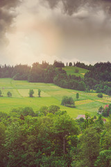 Obraz premium Hills covered with green grass under blue sky
