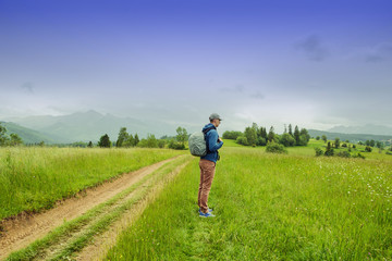 Traveler Man with backpack mountaineering