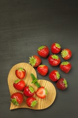 Strawberry on a wooden background. Advertising for the sale of fresh strawberries.
