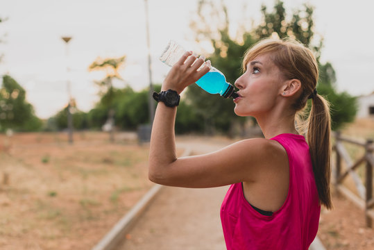 Young woman drinking after running