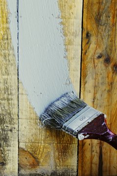 Brush painting a retro color on the wood planks