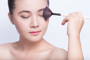 Beauty shot of woman holding the makeup brush