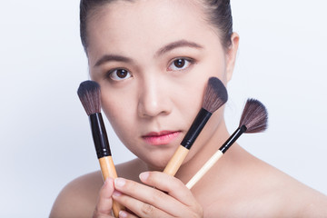 Beauty shot of woman holding the makeup brush