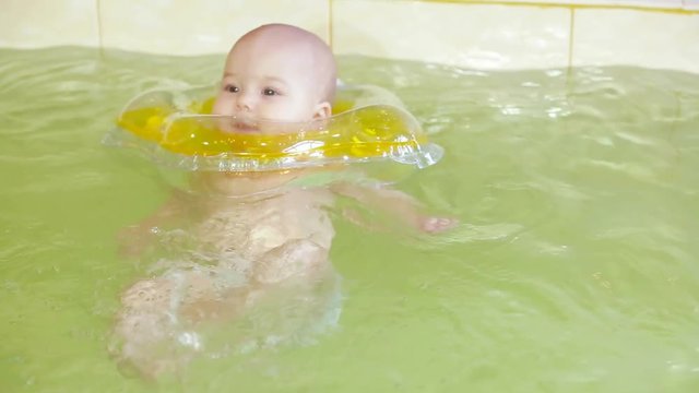 Baby swimming in the pool