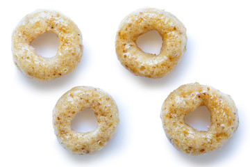 Collection of four honey cheerios isolated on white from above.