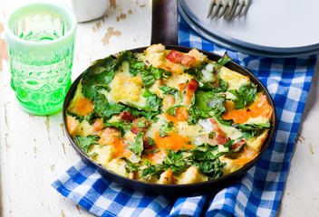 Skillet Strata with Bacon, Cheddar, and Greens