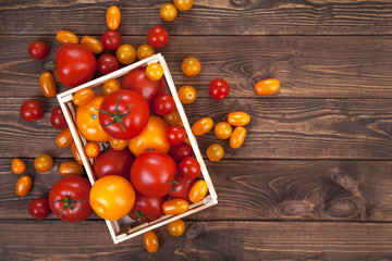 Tomato on wooden table, top view