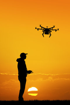man with drone at sunset